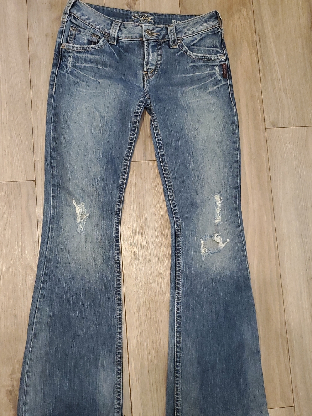 Silver Jeans Women's Mid-Blue Flare Jeans with Distressing